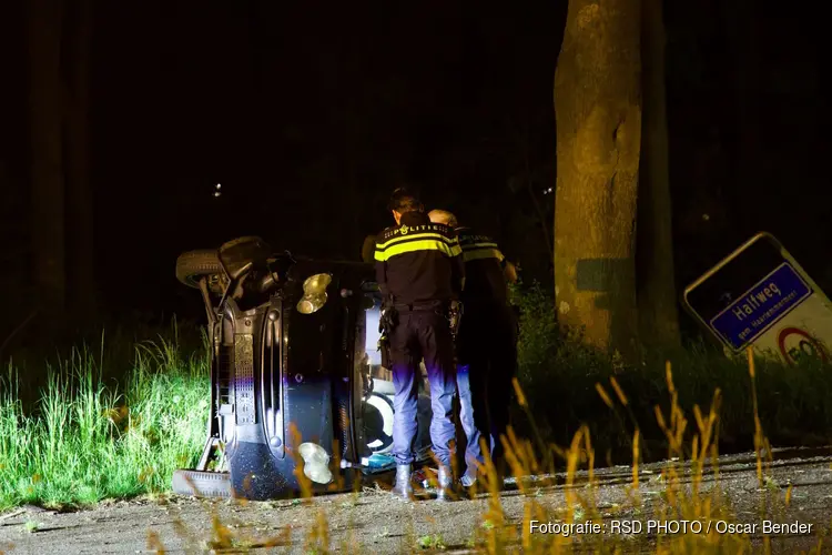 Auto op zijn kant bij Halfweg, bestuurder gevlogen